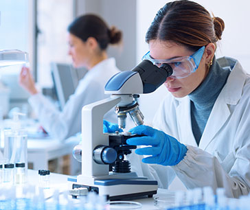 Doctor examining samples under a microscope