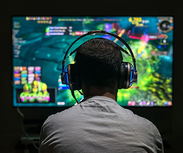 Person viewing and exploring AI-driven video games on big screen